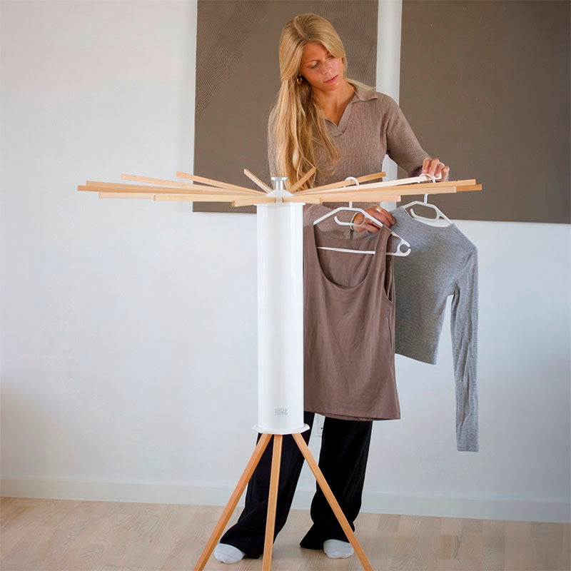 Woman by a SmartRack drying rack – compact drying solution for a flat