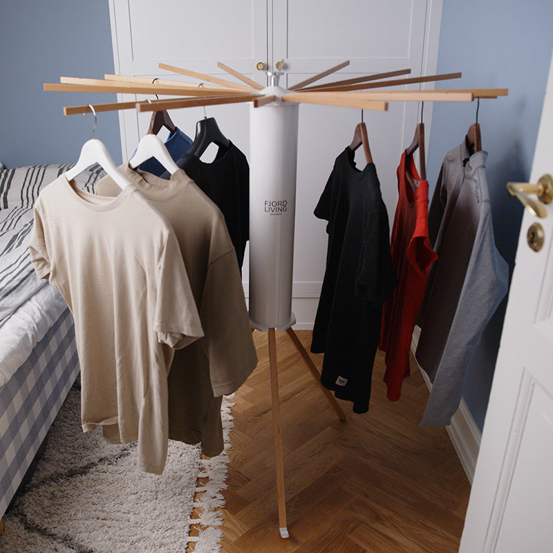 SmartRack drying rack in a bedroom next to the bed